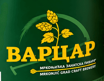 The Varcar beer label of the Mrkonjić Grad craft brewery — hops and barley inside the curve of a scythe, the name ВАРЦАР beneath